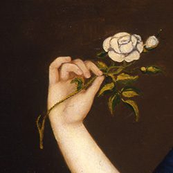 young woman's hand holding a flower