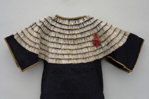 Artist formerly known [Apsáalooke (Crow/Absaroke) or Niitsitapil (Blackfoot/Blackfeet)], Blue Wool Dress with Dentalium Shells (detail) , ca. 1875. Wool, shells, and ribbon, 36 1/4 x 32 x 1 1/2 in. Collection of Shelburne Museum, gift of Ogden M. Pleissner. 1961 - 182.72. Photography by Pitkin Studio, Rockford, IL, USA.