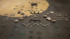 Kite (Oglála Lakȟóta),Iron Road, in collaboration withCorey Stover and Becky Red Bow, installation atTinworks Art, Bozman, MT,2021.Single-channel video, stones, and drone.Courtesy of the artist. © Kite. Photography by Ryan Parker.